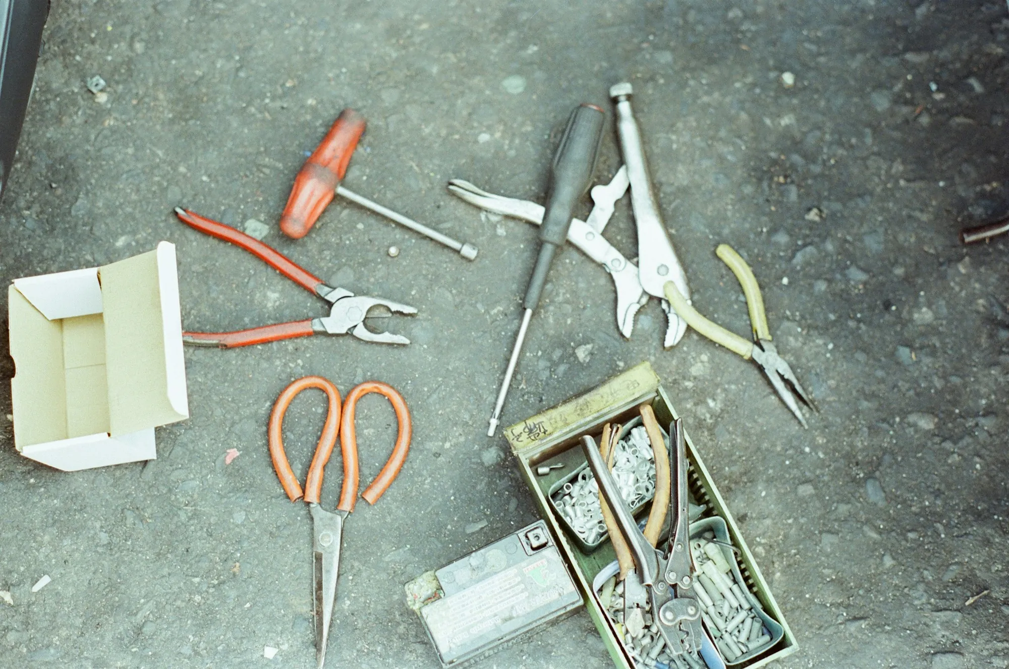 Hand tools and wire connectors scattered on a concrete floor