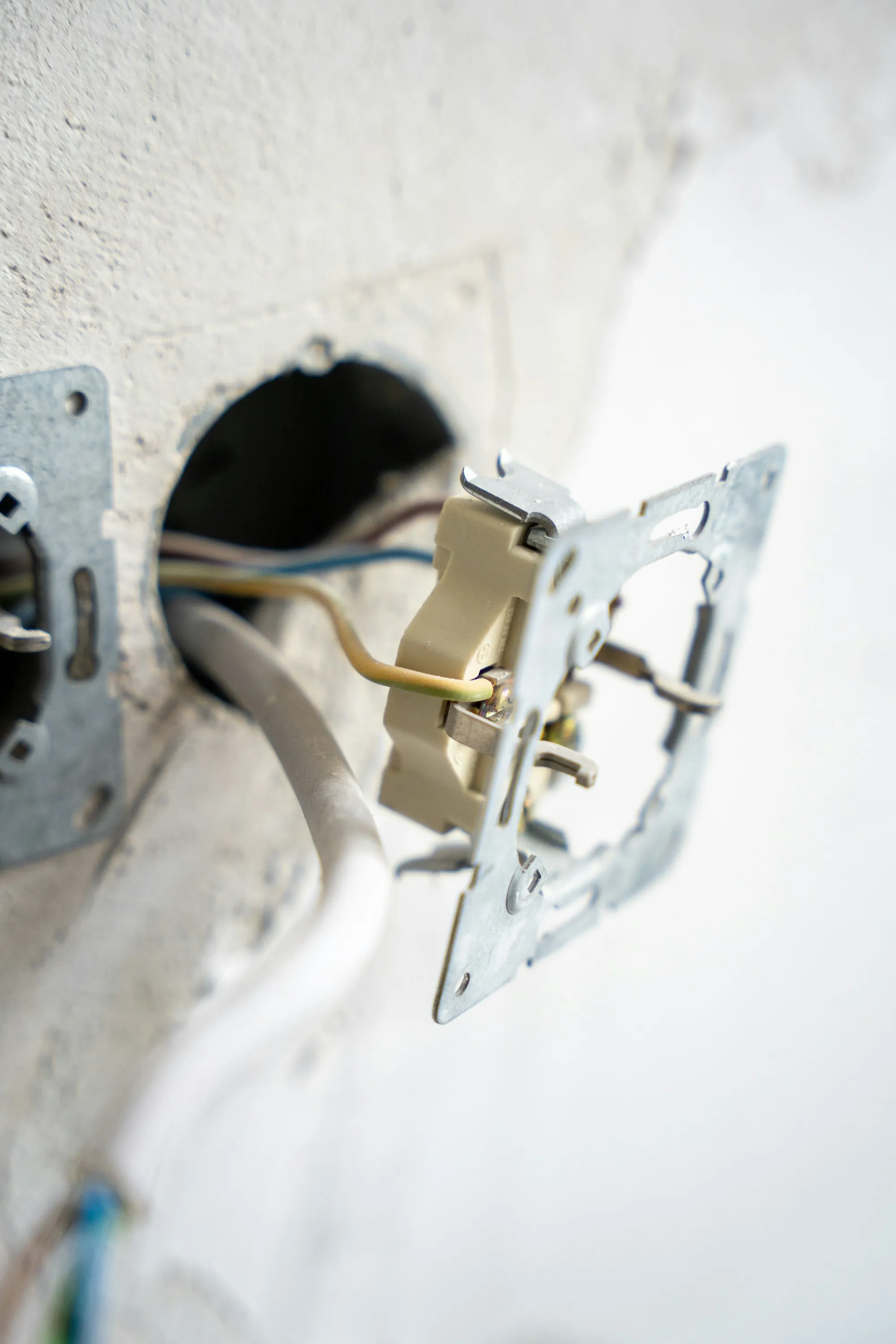 Open electrical box in a wall awaiting a new device