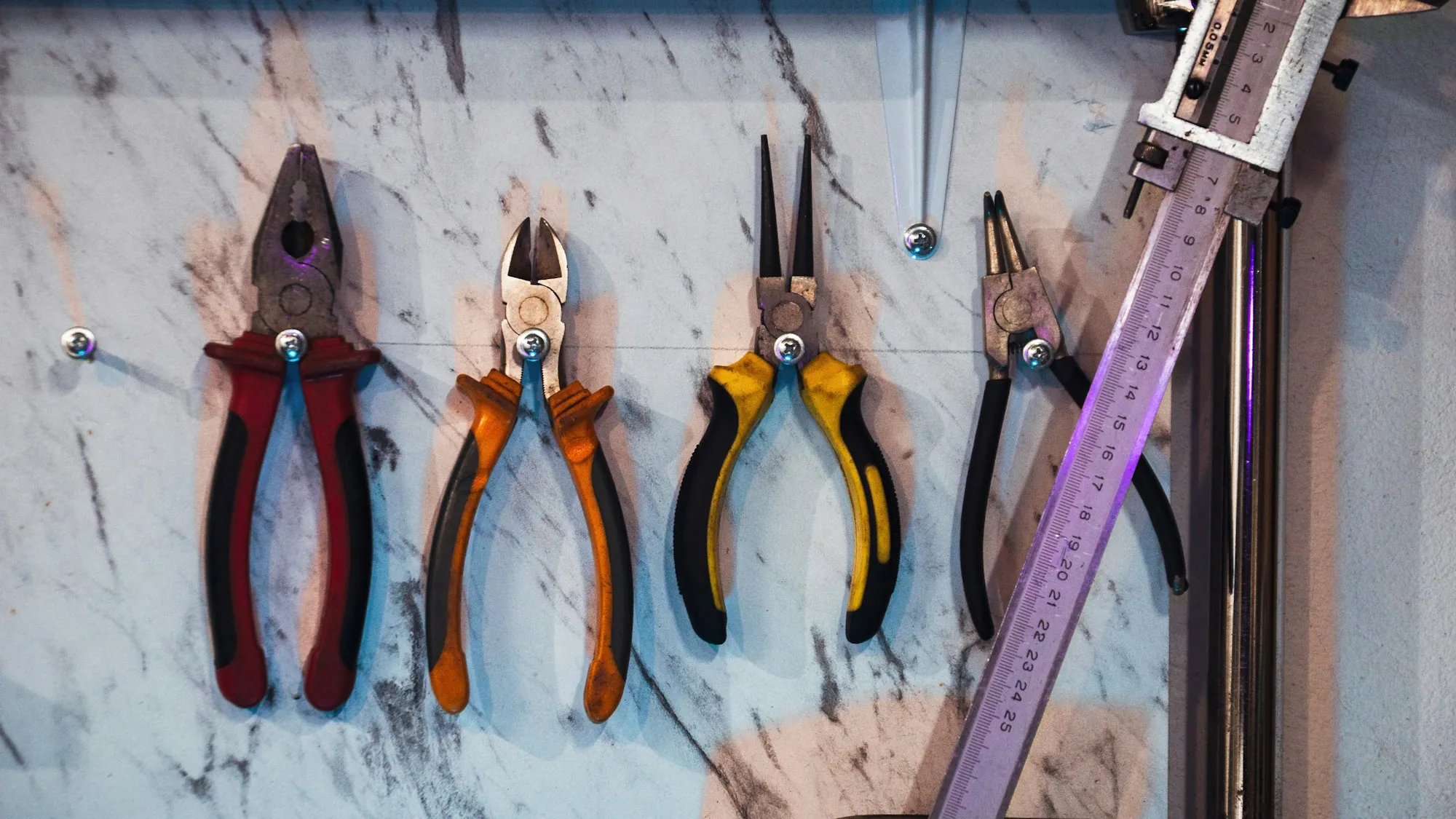 Pliers and cutters hanging on a workshop wall