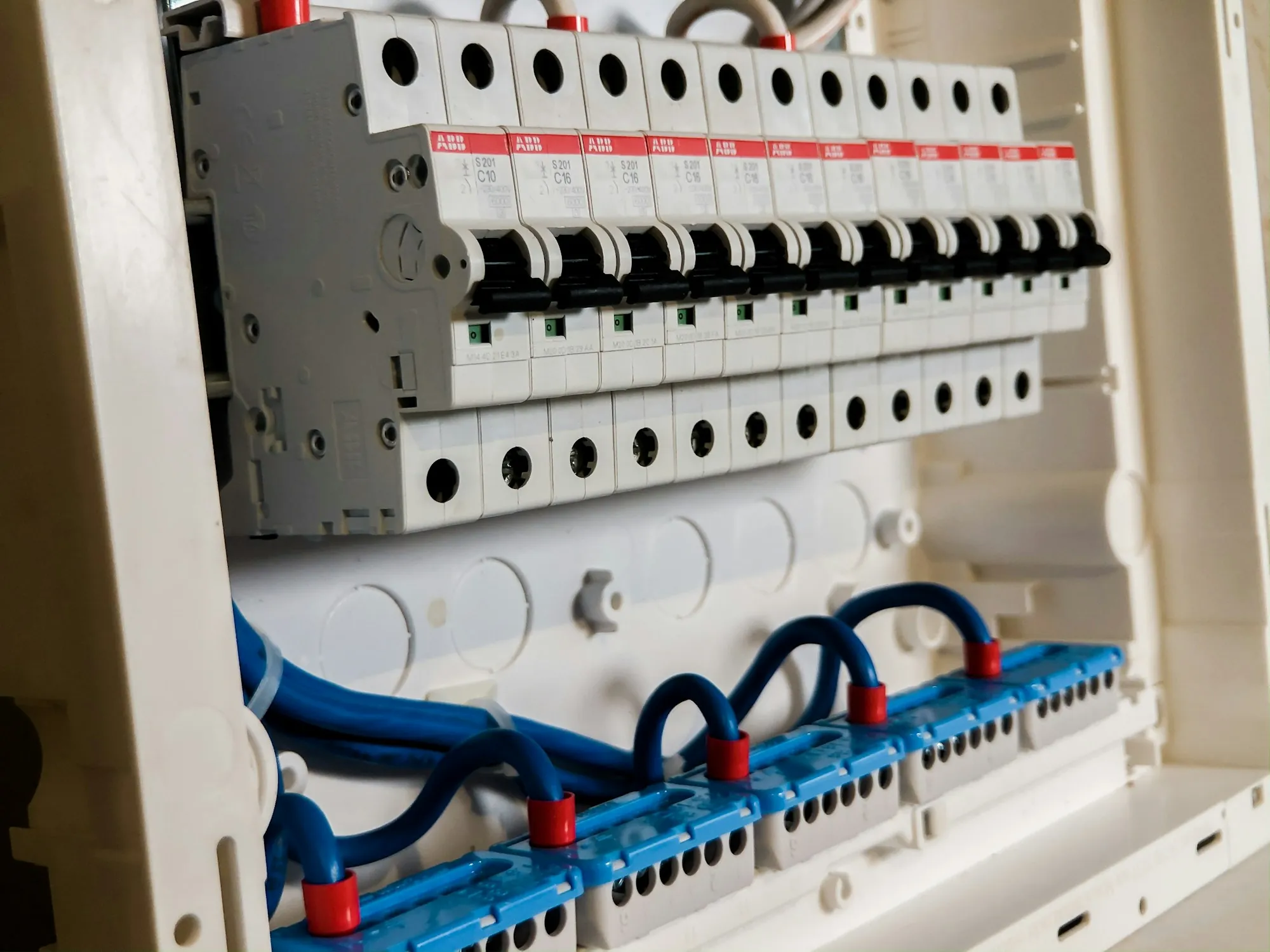Close-up of modular breakers and wiring inside a panel