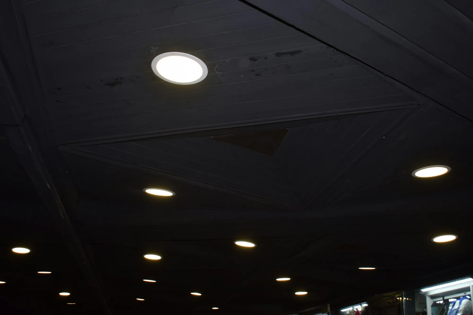 Recessed downlights glowing in a dark ceiling
